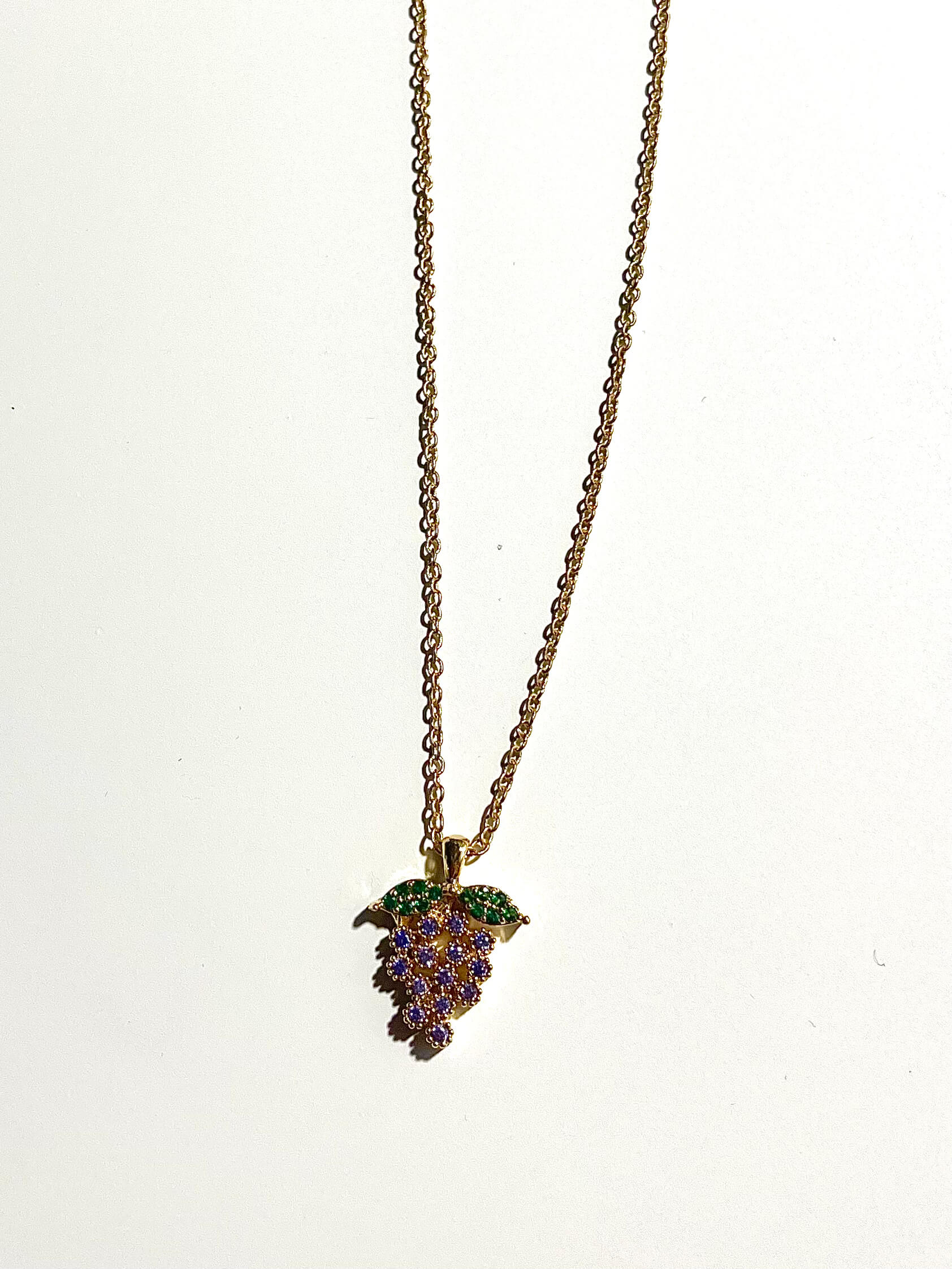 Crystal grape charm on a vintage chain with white background