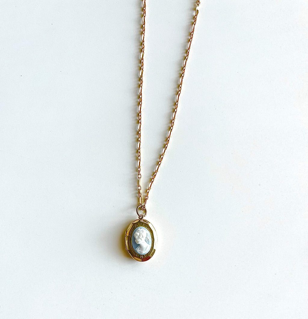 Orange and white cameo locket necklace on white background